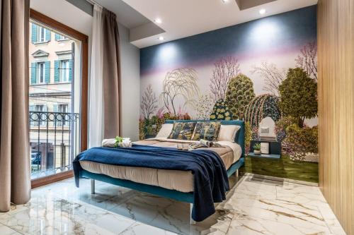 a bedroom with a bed with a painting on the wall at Ugo Bassi Apartments in Bologna