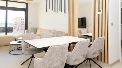 a dining room with a table and chairs at SUNSET SAILORS lovely apartment in Benidorm
