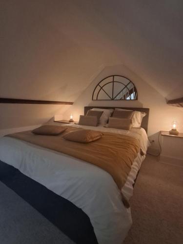 a bedroom with a large bed with two lights on it at Gîte classé 3 étoiles - Morlaix in Morlaix