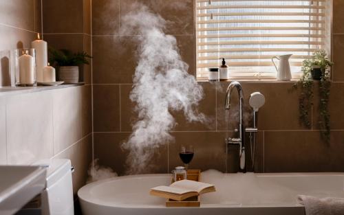 a bathroom with a bath tub with smoke coming out of it at Landal Hexham Lodges in Slaley