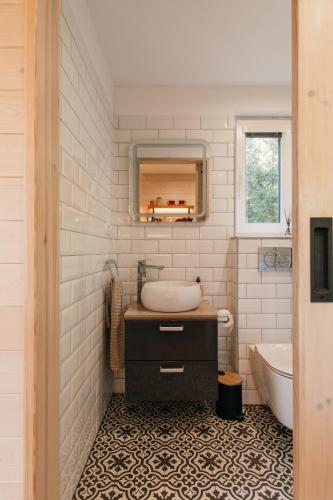 a bathroom with a sink and a tub and a toilet at Tiny Vacation in Písek