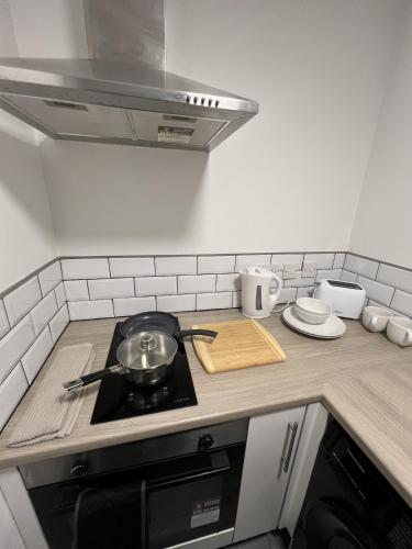 a kitchen with a stove with a pot on it at Modern Studio Central WV1 Appt 4 in Wolverhampton