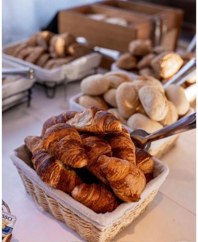 a basket of croissants and other baked goods on a table at Tandreas Hotel & Restaurant in Gießen