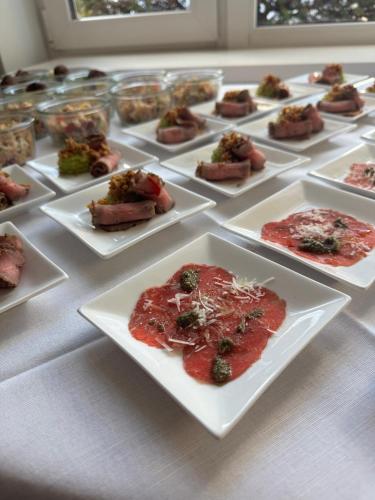 a bunch of plates of food on a table at Tandreas Hotel & Restaurant in Gießen