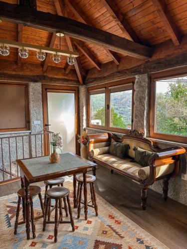 a living room with a couch and a table at Casa do Cabeço de Boi by Refúgio ao Luar in Terras de Bouro