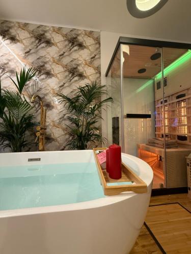 a bath tub with a red candle in a bathroom at Ama Esclusive Spa Florence in Florence