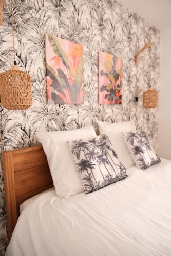 Saint-Yzan-de-SoudiacJungle Room et Jacuzzi的卧室里有一张带白色枕头的床