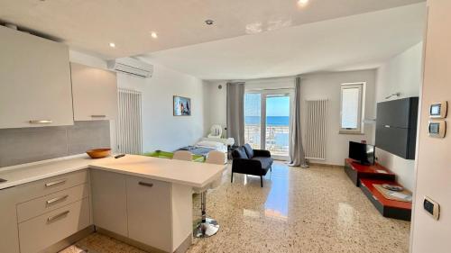 cocina y sala de estar con vistas al océano en Le Murrine Frontemare Apartment Sea View 503, en Chioggia
