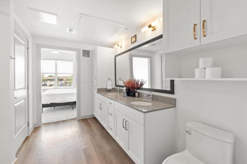 a white bathroom with a sink and a toilet at Large Lively Apt in San Marcos