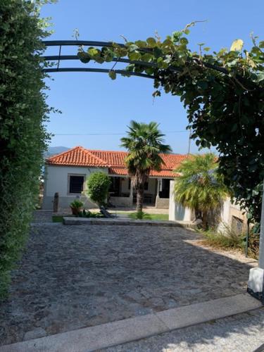 a house with a gate in front of a yard at Villa Elia in Seixas