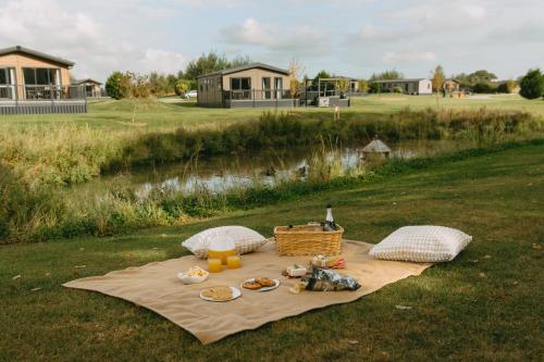 a picnic table with food on a blanket on a field at Landal Angrove in Great Ayton