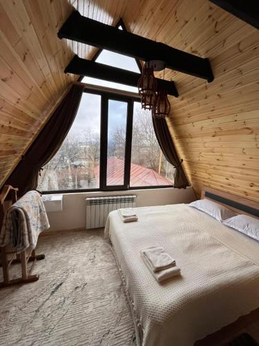a bedroom with a bed and a large window at Aura Frames in Vǝndam