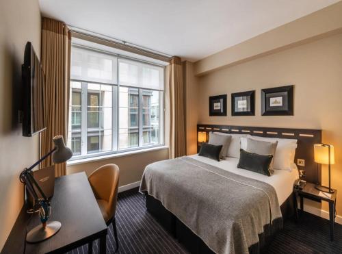 a hotel room with a bed and a window at Tejsvhi Hotel Aerocity in Jāmb