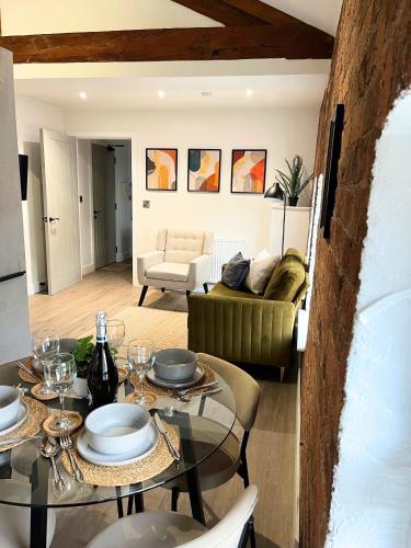 a living room with a table and a couch at Urban City Centre Apartment 1 Private Parking in Hull