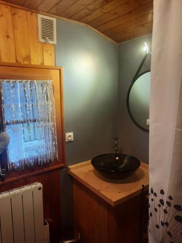 une salle de bains avec un lavabo et un miroir dans l'établissement Chalet mayou, à Châtillon-sur-Cluses