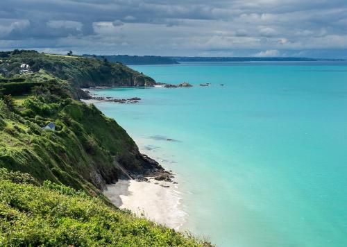 a view of the ocean from a hill with a beach at Appartement d'exception - proche de la mer in Saint-Brieuc