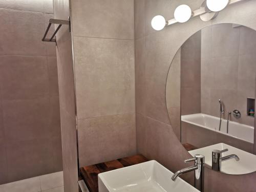 a bathroom with a sink and a mirror at Seepark Weiden - Baumhof in Weiden am See