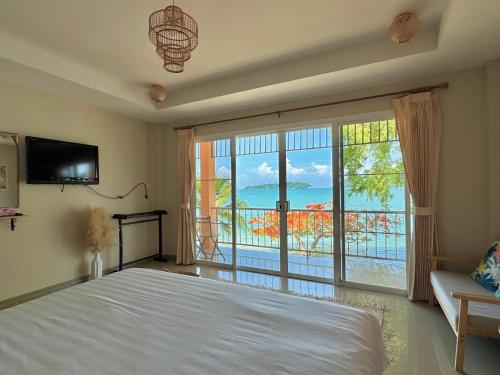 a bedroom with a bed and a large window at Secret Place in Panwa Beach