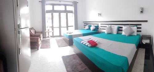 Ένα ή περισσότερα κρεβάτια σε δωμάτιο στο Indunil Family Residence With Pool Hiriketiya