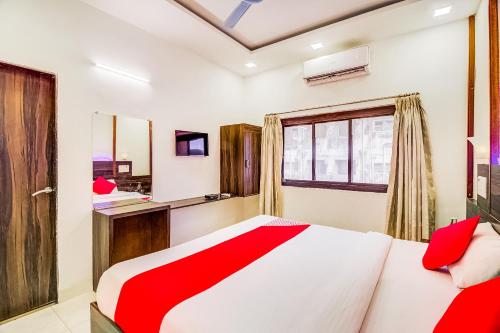 a bedroom with a bed and a window at Collection O Panchratna in Panvel