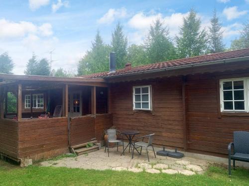 a cabin with a table and chairs in front of it at 6 person holiday home in Fårvang in Fårvang