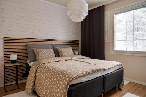 a bedroom with a bed and a window at Cozy and peaceful holiday apartment in Levi in Levi