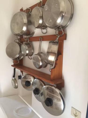 a bunch of pots and pans hanging on a wall at Casa Moser in Stromboli