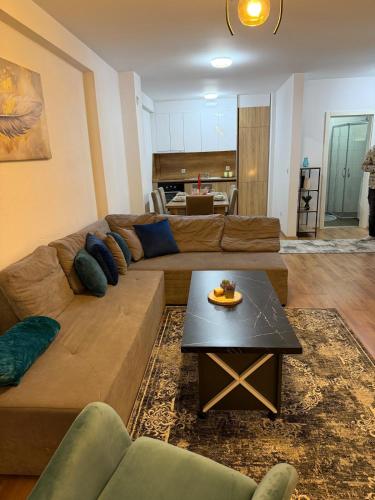 a living room with a couch and a table at A place that will make you feel at your home! in Gjilan
