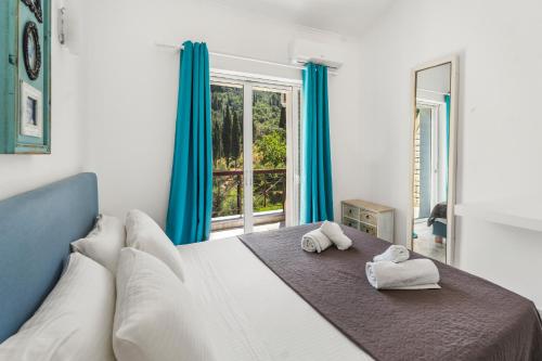 a bedroom with a large bed with towels on it at Doliva Studio John private jacuzzi in Agios Gordios