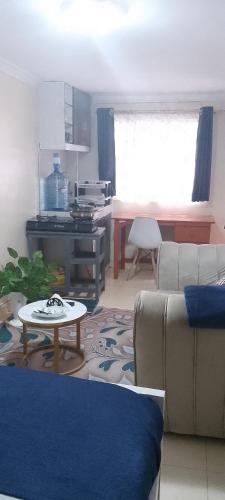 a living room with a couch and a table at Utawala studio apartment in Nairobi