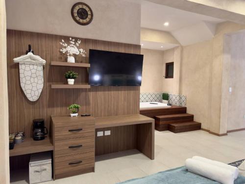 a living room with a flat screen tv on a wall at Loft Mueganos III en Val´Quirico in Santeagueda