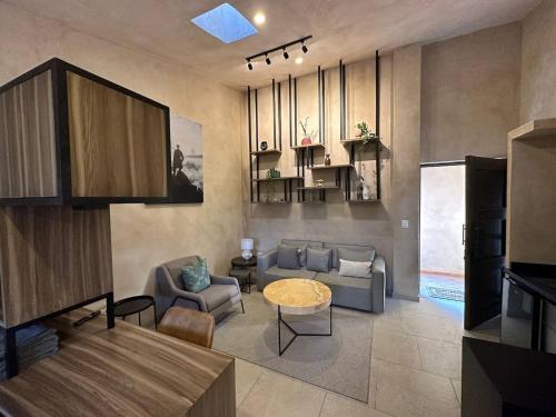 a living room with a couch and a table at Loft Loreto en Val'Quirico in Santeagueda