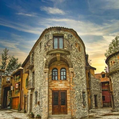 an old stone building with a window on a street at Loft River en el corazon de Valquirico in Santeagueda