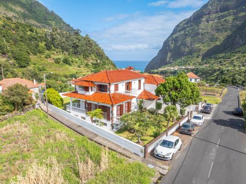 an aerial view of a house with a mountain at Casa do Vale in São Vicente