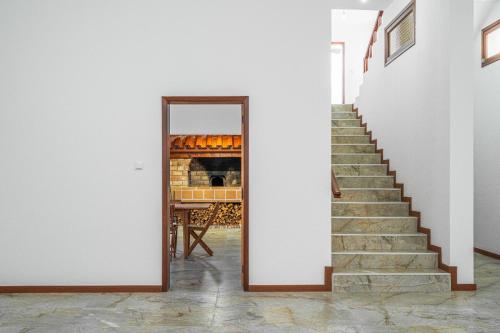 a stairway with a mirror in a room at Casa do Vale in São Vicente