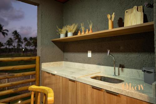 a kitchen with a sink and a wooden counter top at Paraíso no patacho - Rota de Milagres in Pôrto de Pedras