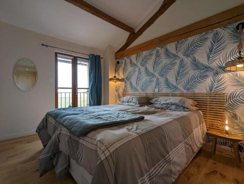 a bedroom with a large bed in a room at Grange des Bardins in Villebois-Lavalette