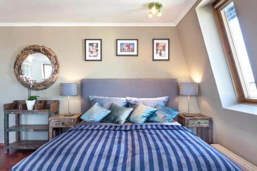 a bedroom with a blue and white bed with two tables at GreatStay Apartment - Danzigerstr. in Berlin