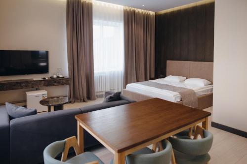 a hotel room with a bed and a table at Asad in Astana