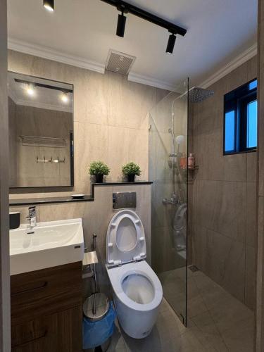 a bathroom with a toilet and a sink and a shower at Villa Maria Luxury in Kamala Beach