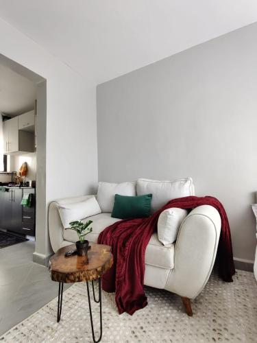 a living room with a white couch and a table at Solara Loft in Nairobi