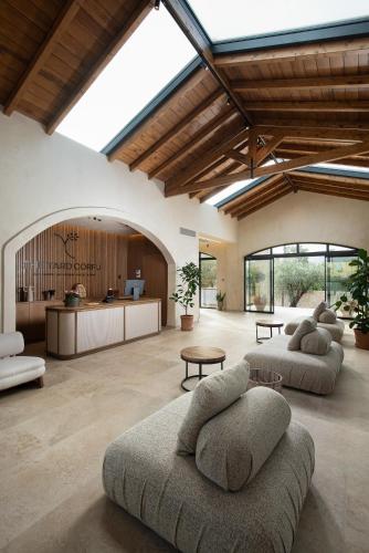 a large living room with two couches and a table at The Yard Corfu Boutique Hotel and Spa in Moraitika