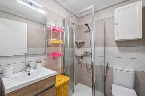 a bathroom with a sink and a shower and a toilet at Geani in La Marina