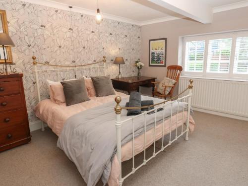 a bedroom with a bed and a desk and a chair at Daleholme in Barnard Castle