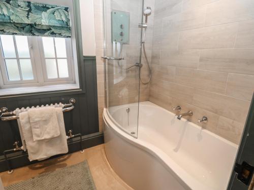 a bathroom with a bath tub and a window at Daleholme in Barnard Castle
