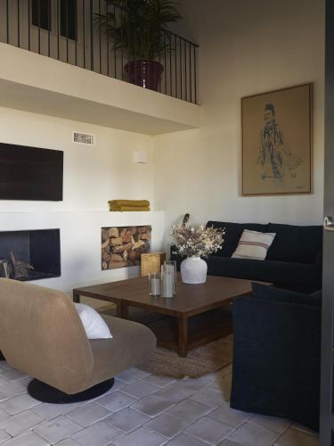 a living room with a couch and a coffee table at Capricho de Doñana in El Rocío