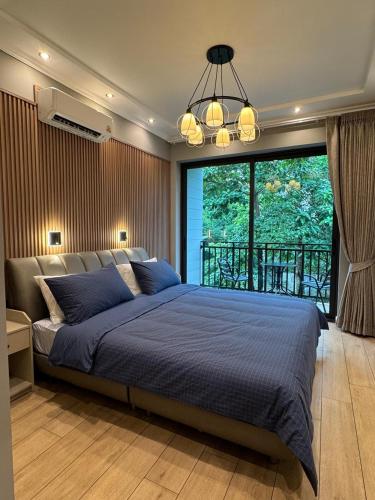 a bedroom with a large bed and a large window at Villa Maria Luxury in Kamala Beach