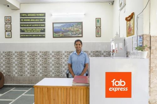 a man standing behind a counter at a fast food restaurant at FabHotel ASP Royal Residency Inn- Janakpuri in New Delhi