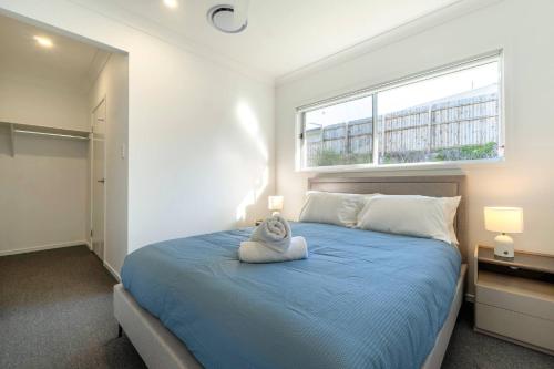 Ένα ή περισσότερα κρεβάτια σε δωμάτιο στο Aspen Serenity–Modern Family Home in Logan Reserve