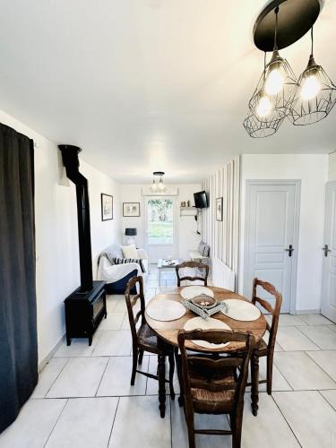a dining room with a table and chairs and a fireplace at Coté Baie-Plage à 15min-Dog friendly-Parking clos in Villers-sur-Authie